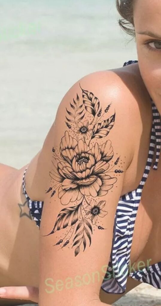 flower and leaves tattoo on woman at the beach